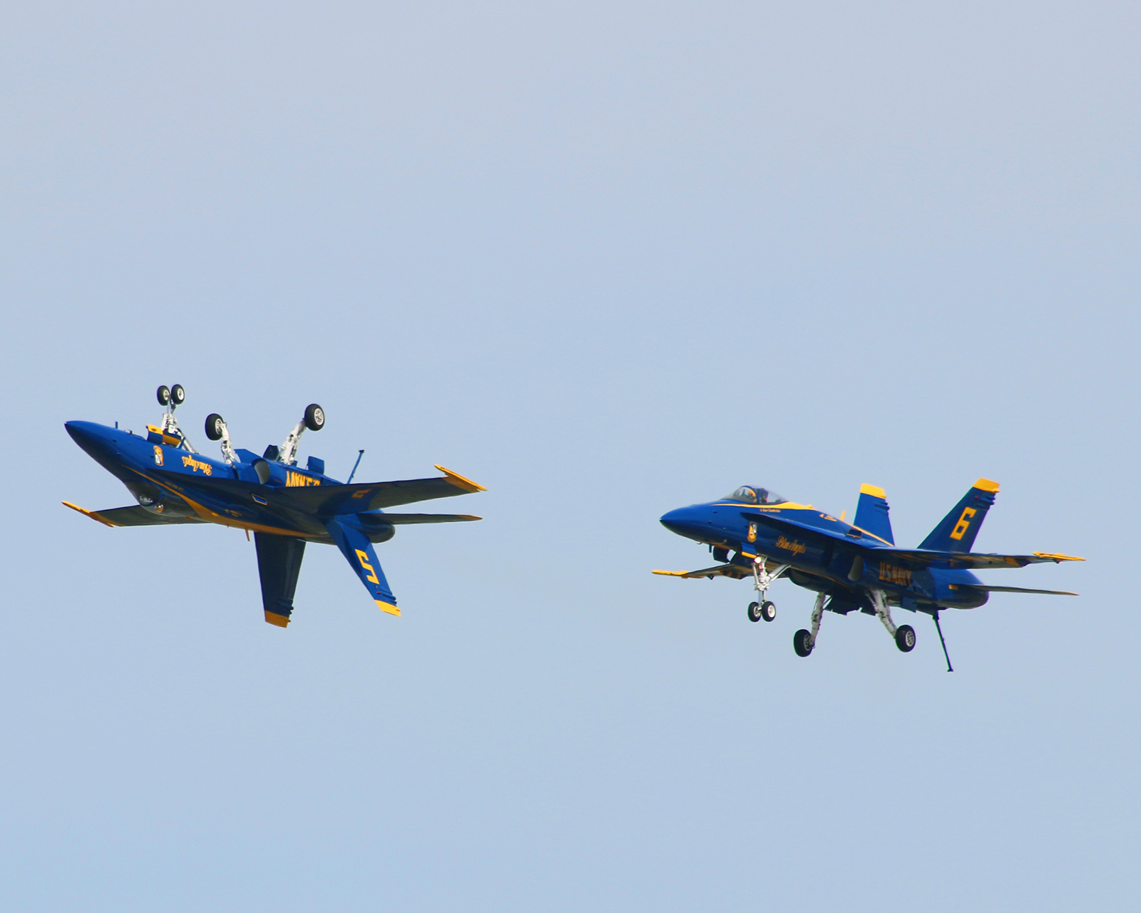 The solos depicted in the picture showcase the inverted and systematic flight of the pilots wheels down. I found this position amazing as the speeds seem slower than earlier maneuvers and it almost looked like a mirror picture of the planes. The only differences is their tale numbers. If I had to name this picture I would call it Up and Down. I like this one because of the viewpoint. The straight on shot doesn't show both planes like this viewpoint. It has been a beautiful weekend and I am glad I was able to go and get some pictures of all the shows performers.